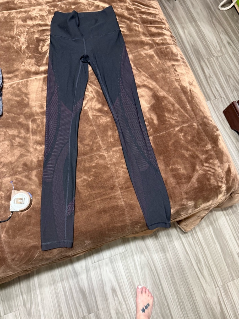 Woman’s size 4 Lululemon black and purple leggings